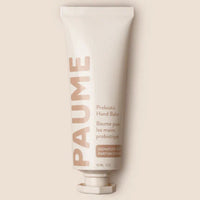 A white tube of PAUME Probiotic Hand Balm with minimalistic design, placed against a plain background.