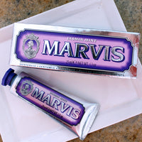Marvis toothpaste tube and packaging on a marble surface